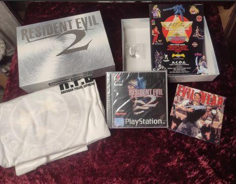 Jeu vidéo Resident Evil 2 avec accessoires sur une surface rouge foncé, collection de jeux vidéo rétro, xénoglosse, gaming, console PlayStation, édition limitée.