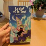 Un jeu de société pour enfants avec une illustration d’un château magique et un chat noir, parfait pour stimuler l’imagination et l’aventure. Livre de jeux captivant, idéal pour les jeunes amateurs d’aventures fantastiques.