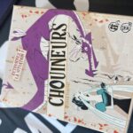 Jeu de société Chouineurs avec illustration de dragons et personnages fantastiques, parfait pour les amateurs de jeux de stratégie et d'aventure.