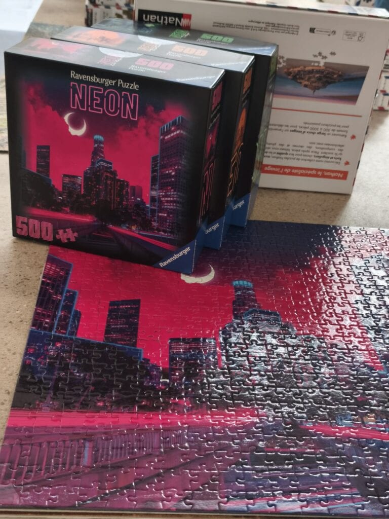 Puzzle Ravensburger Neon, 500 pièces, image de skyline urbaine illuminée la nuit, idéal pour les passionnés de puzzles et de décoration moderne.