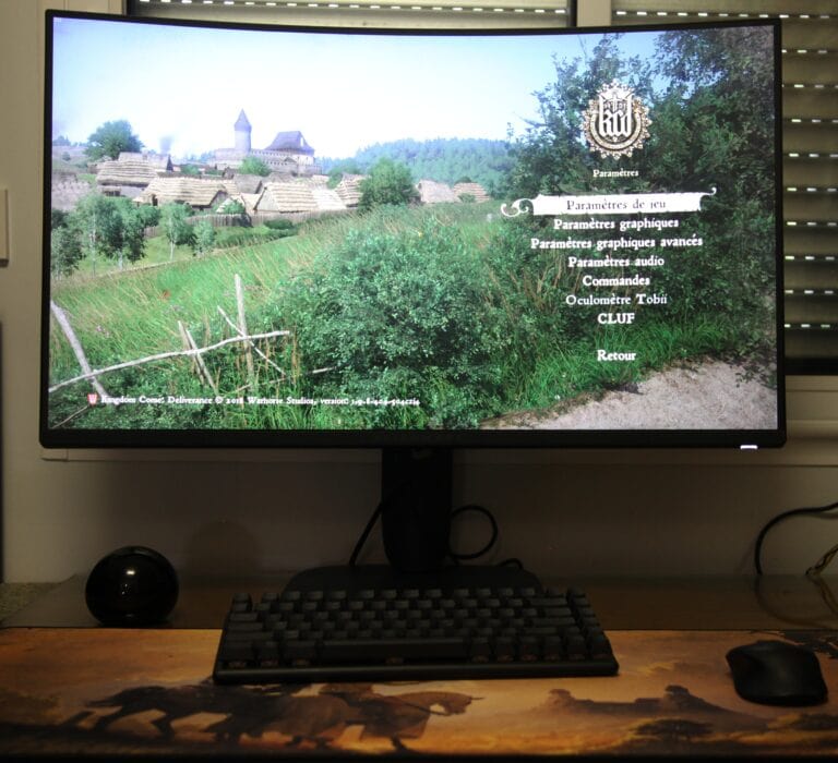Écran d'ordinateur affichant un menu de paramètres en français, avec un paysage rural en arrière-plan.