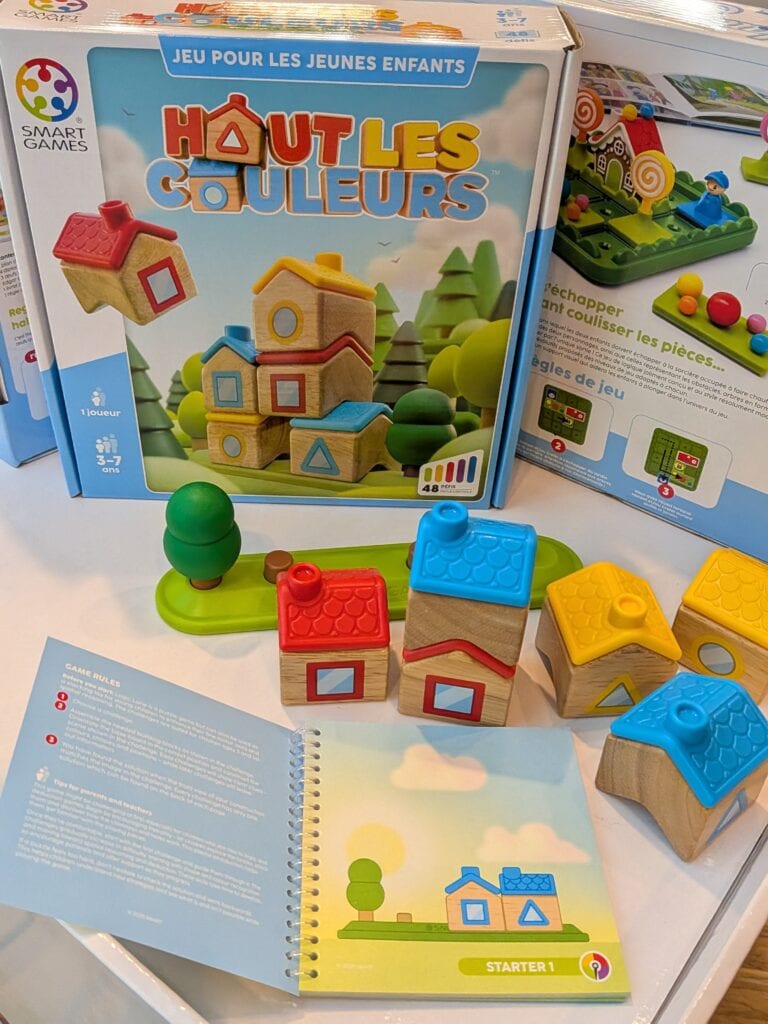 Jeu de construction Hout Les Couleurs avec maisons en bois colorées et pièces de jeu pour enfants, idéal pour stimuler la créativité et la coordination.