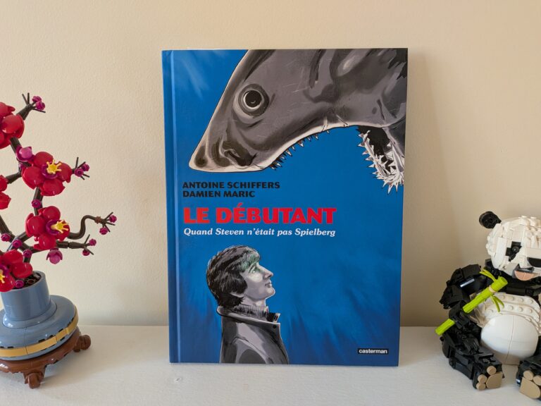 Couverture du livre 'Le Débutant' de Damien Maric et Antoine Schiffers, illustrant un requin menaçant et un jeune homme.
