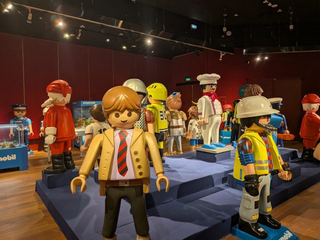 Exposition éphémère de figurines Playmobil avec plusieurs personnages en vitrine à Drouot.