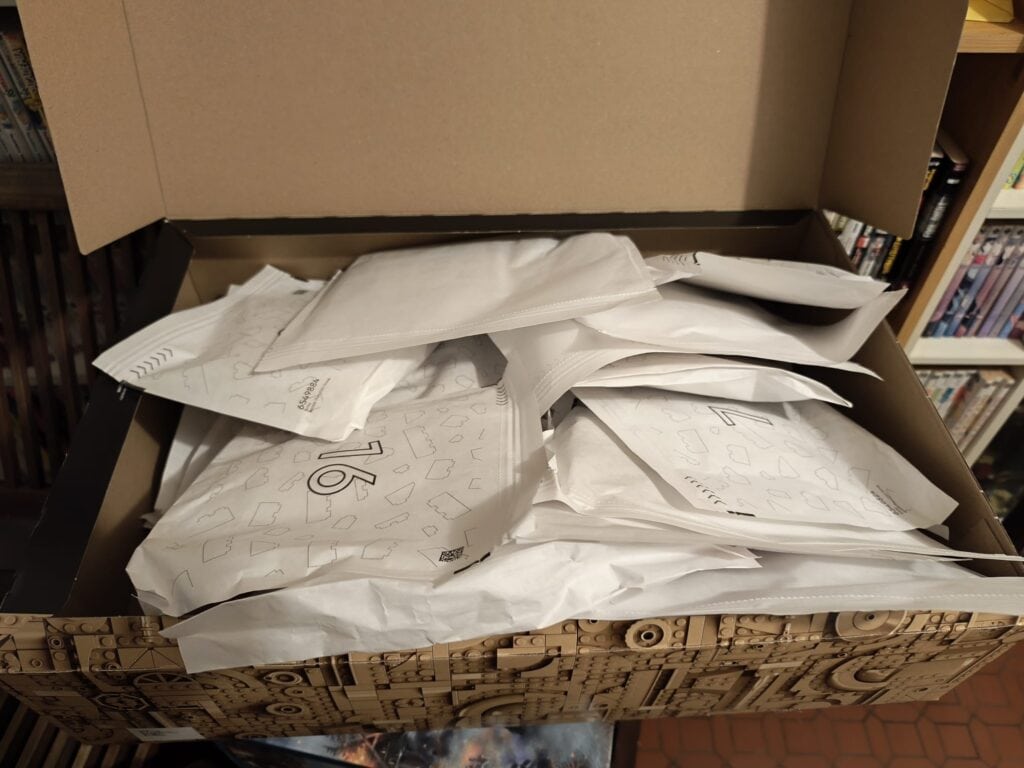 Boîte en carton remplie de papiers et documents, ouverte sur une étagère de bibliothèque.