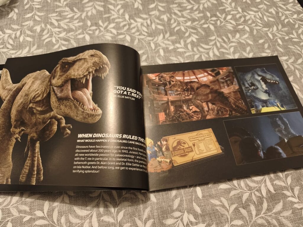 Image d'un livre sur les dinosaures avec un modèle LEGO du Tyrannosaurus rex et des illustrations de dinosaures.
