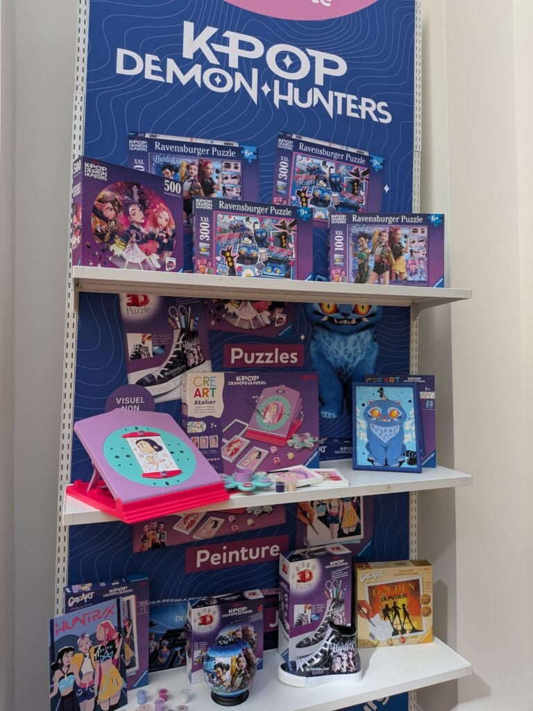 Vitrine avec puzzles, jeux de société et jouets à l'effigie de KPOP Demon Hunters pour Noël 2026.