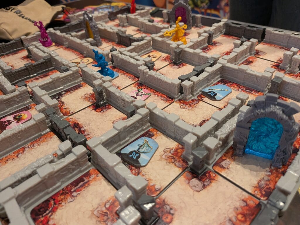 Plateau de jeu de société Dungeon Crawler avec figurines colorées et cartes d'action.